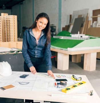 african-american-woman-with-ruler-table-near-safety-helmet-equipments_11zon